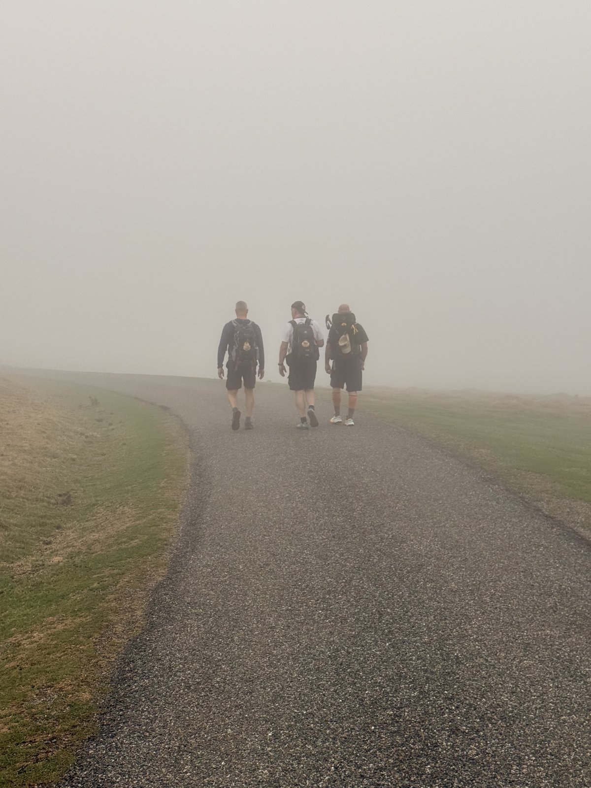 Three walkers among the clouds at 1,400 metres
